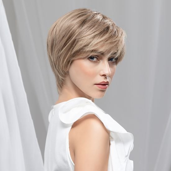 Model wearing a short layered blonde human hair piece