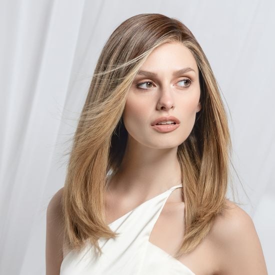 Model wearing a long layered honey blonde human hair piece