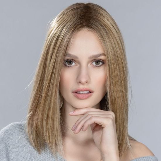 Model wearing a long straight honey blonde hair topper