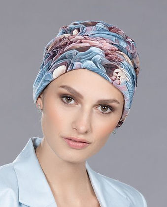Model wearing a blue and mauve patterned turban cap