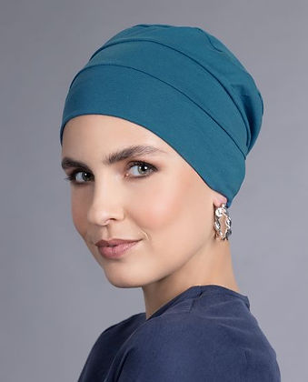Model wearing a teal pleated turban cap
